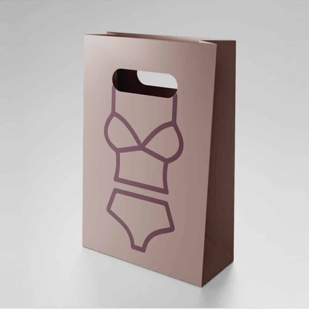 Rosafarbene Shopping-Tasche für ein Wäschegeschäft mit minimalistischer Illustration eines Dessous-Sets als Teil eines Marken- und Verpackungsdesigns.